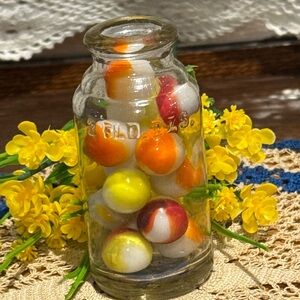 Clear Vintage-like Glass Bottle with Yellow, Orange,White and Red Marbles
